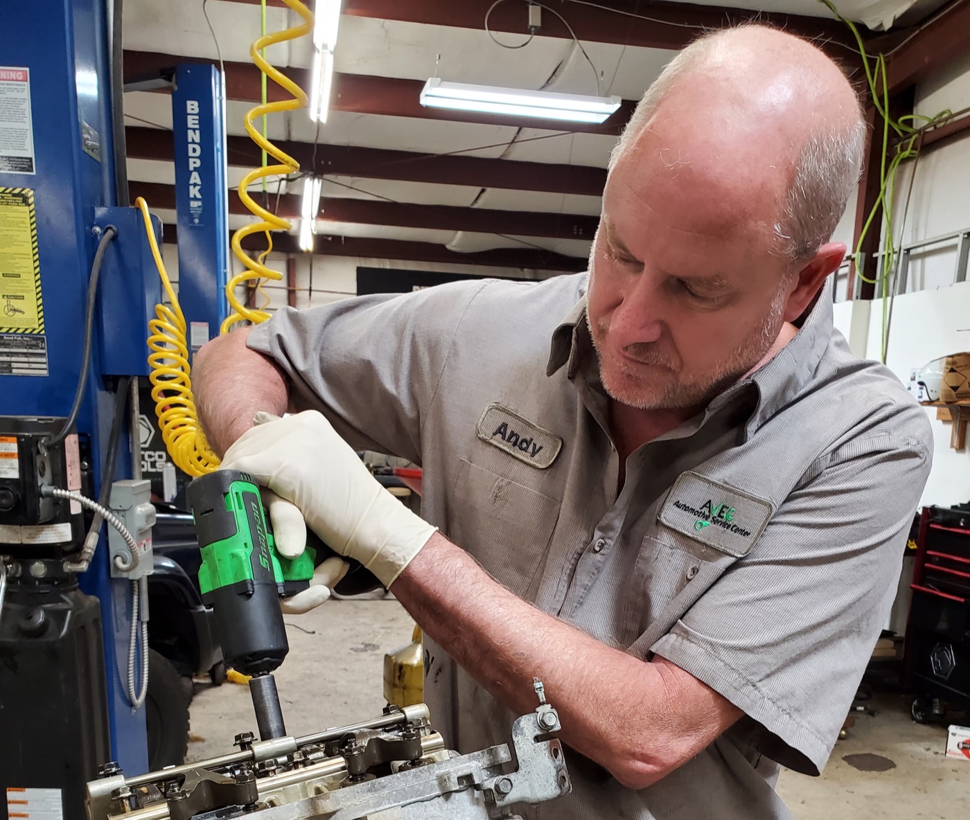 AVEC technician servicing a vehicle in the shop